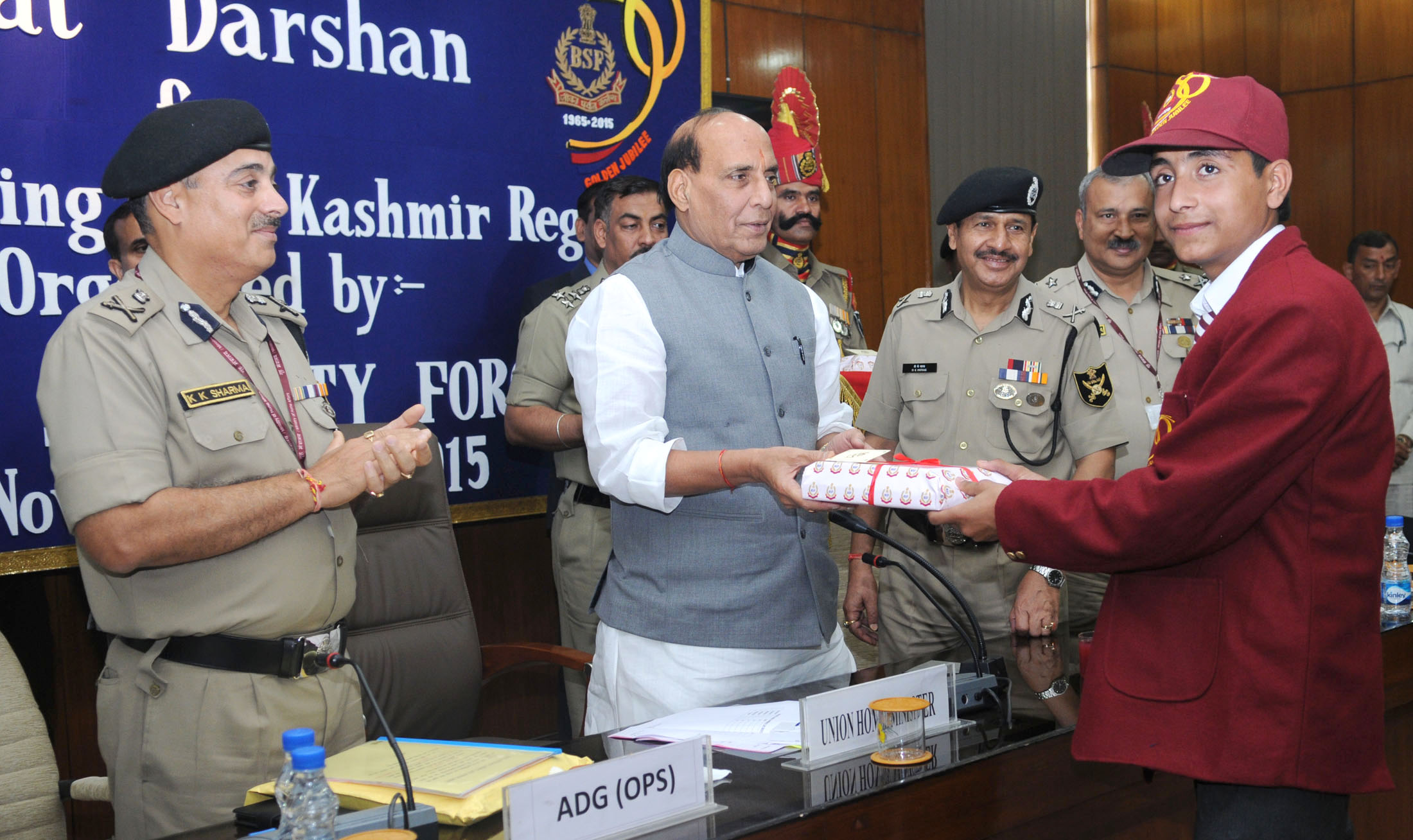 The Union Home Minister, Shri Rajnath Singh presenting gift to the school children from Kashmir region who are on a Bharat Darshan tour being conducted by the Border Security Force, in New Delhi on November 13, 2015. 	The Director General, BSF, Shri D.K. Pathak is also seen.