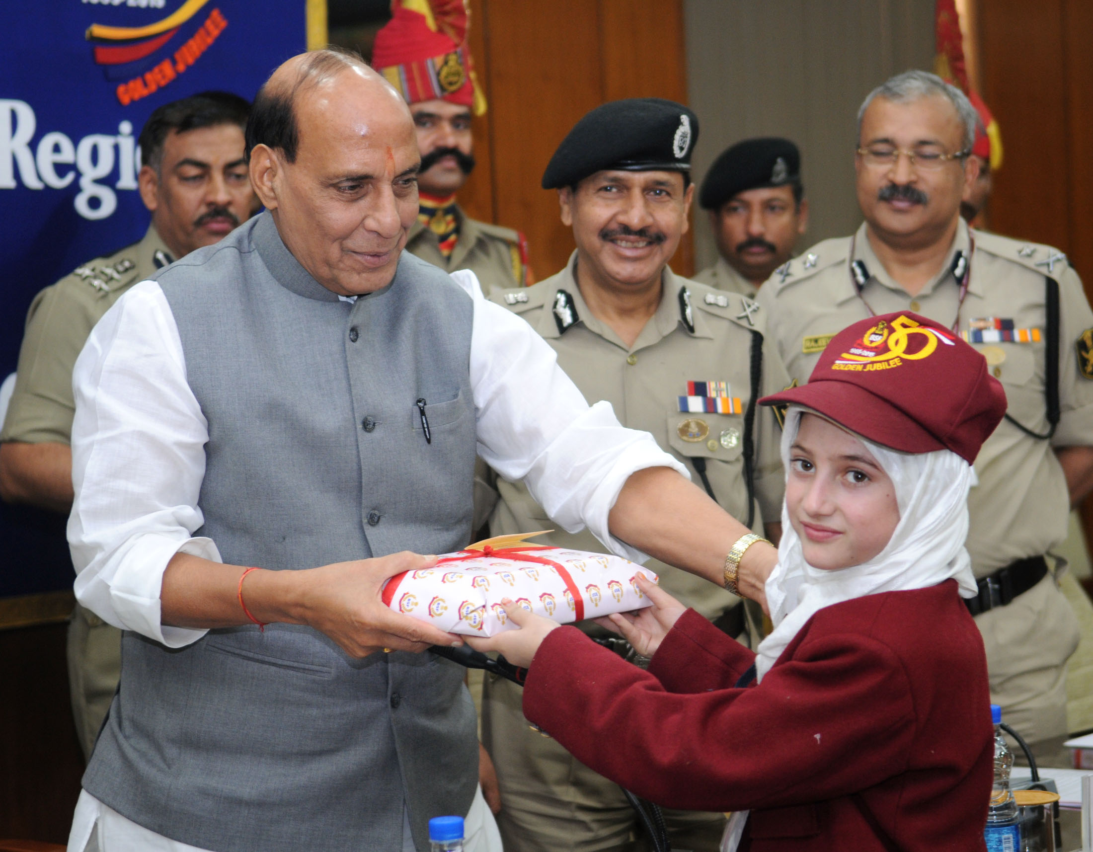 The Union Home Minister, Shri Rajnath Singh presenting gift to the school children from Kashmir region who are on a Bharat Darshan tour being conducted by the Border Security Force, in New Delhi on November 13, 2015. 	The Director General, BSF, Shri D.K. Pathak is also seen.