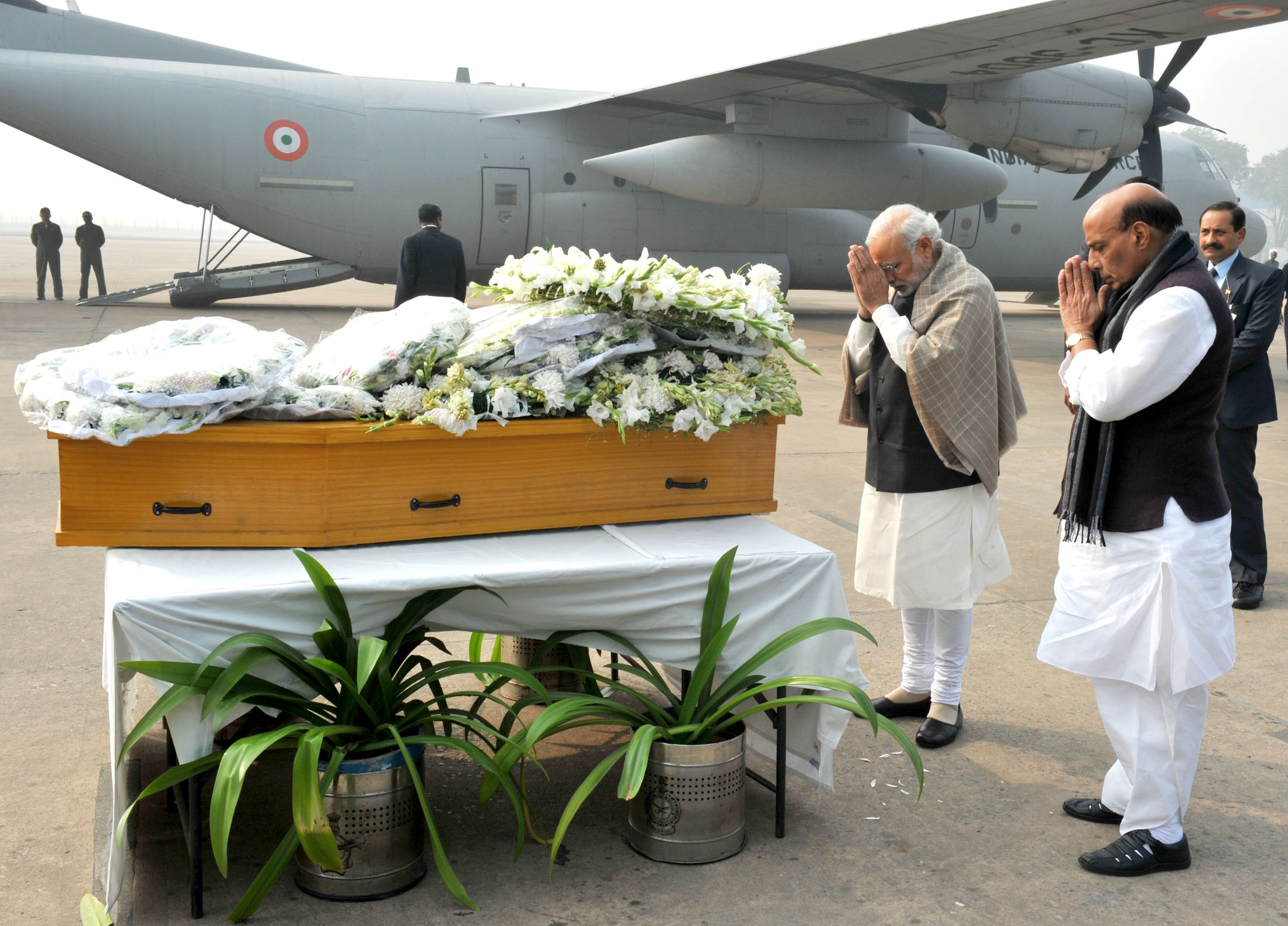 The Prime Minister, Shri Narendra Modi paying homage at the mortal remains of Shri Mufti Mohammad Sayeed, at Palam Airport, in New Delhi on January 07, 2016.   	The Union Home Minister, Shri Rajnath Singh is also seen.