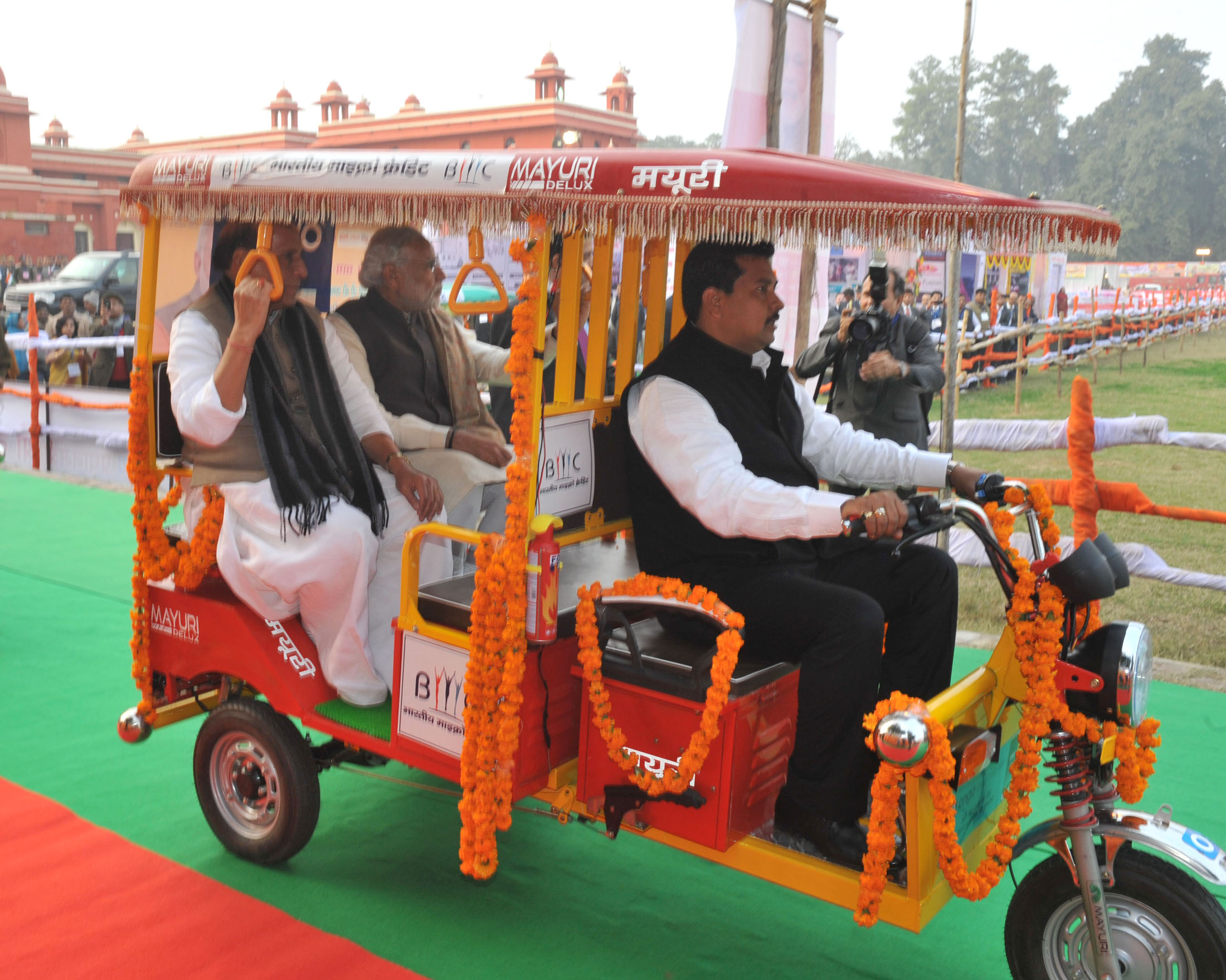 The Prime Minister, Shri Narendra Modi taking a ride on E-Rickshaw, after the distribution at Rickshaw Sangh programme by the Bhartiya Micro Credit, in Lucknow, Uttar Pradesh on January 22, 2016.  	The Union Home Minister, Shri Rajnath Singh is also seen.