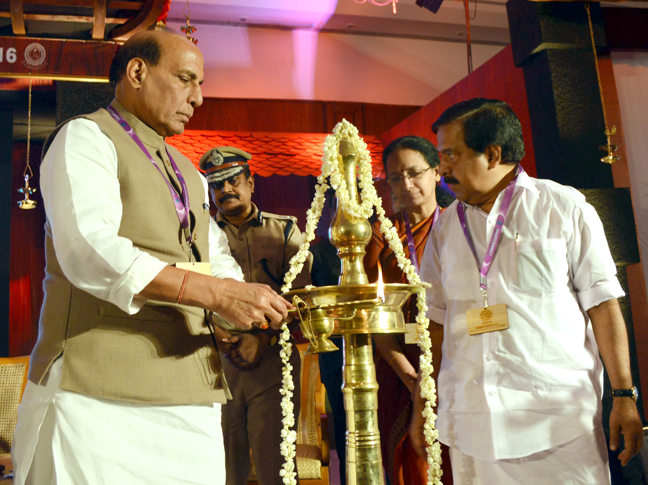 The Union Home Minister, Shri Rajnath Singh lighting the traditional lamp to inaugurate the National Conclave on Community Policing, at Kovalam, in Thiruvananthapuram Kerala on January 27, 2016.  	The Kerala Home Minister, Shri Ramesh Chennithala, the State Home Secretary, Smt. Nalini Netto and the State DGP, T.P. Senkumar are also seen.