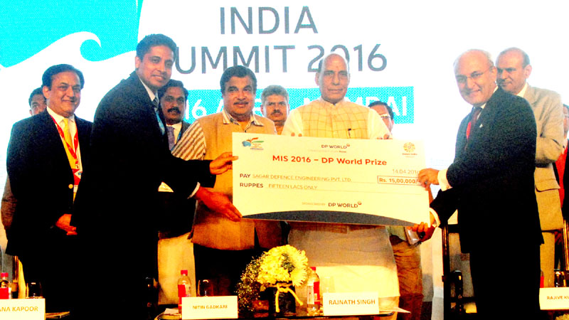 The Union Home Minister, Shri Rajnath Singh presenting the cheque Rs.15/- lakh to Capt. Nikunj Paras for winning MISZO16 DP world prize, at the Maritime India Summit, in Mumbai on April 15, 2016. 	The Union Minister for Road Transport & Highways and Shipping, Shri Nitin Gadkari and the Secretary, Ministry of Shipping, Shri Rajive Kumar are also seen.