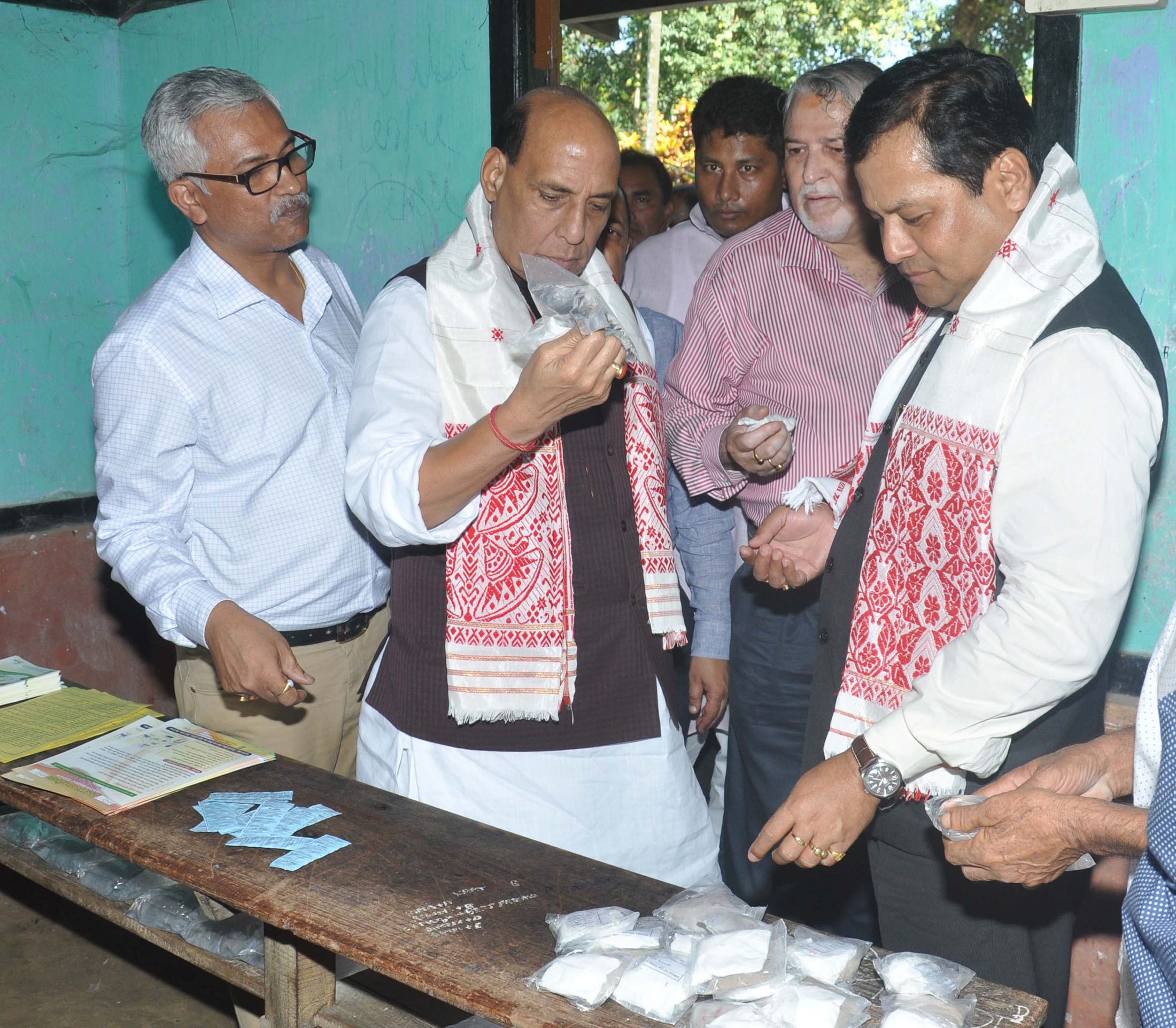 The Union Home Minister, Shri Rajnath Singh inspecting the relive material at flood relive camp, at Morigaon District of Assam on July 30, 2016. 	The Chief Minister of Assam, Shri Sarbananda Sonowal is also seen.
