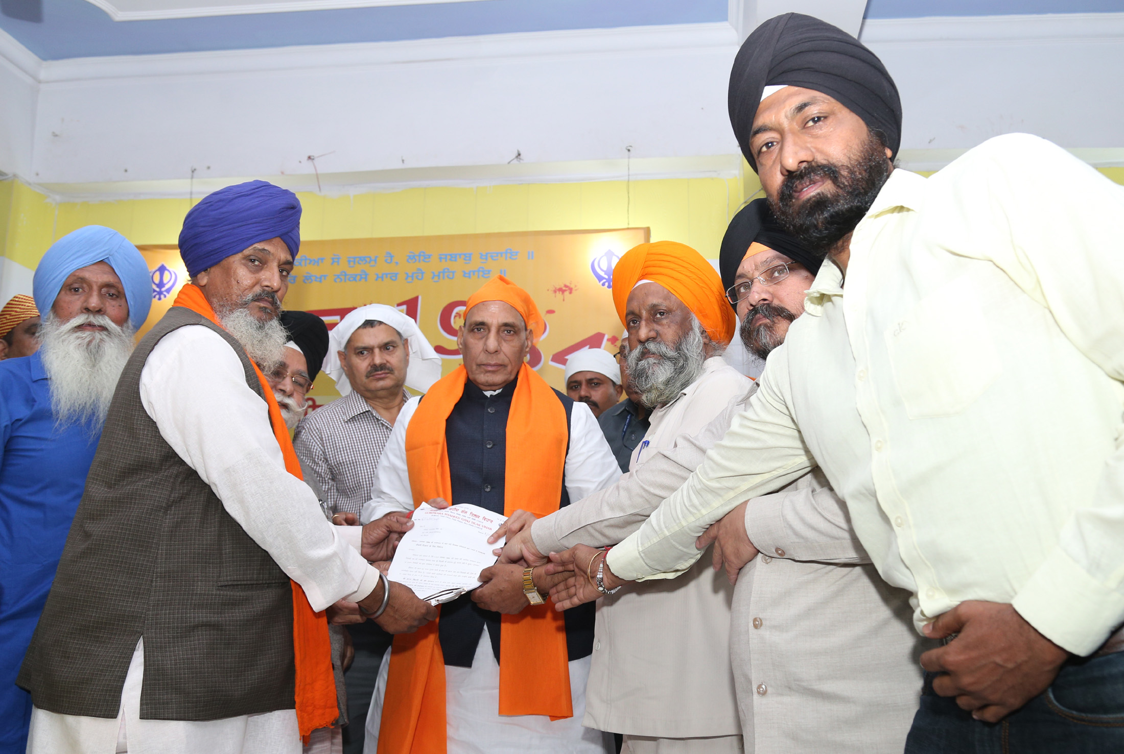 The Union Home Minister, Shri Rajnath Singh receiving a memorandum, during a programme to mark the anniversary of the 1984 Sikh riot victims, in New Delhi on November 02, 2016.