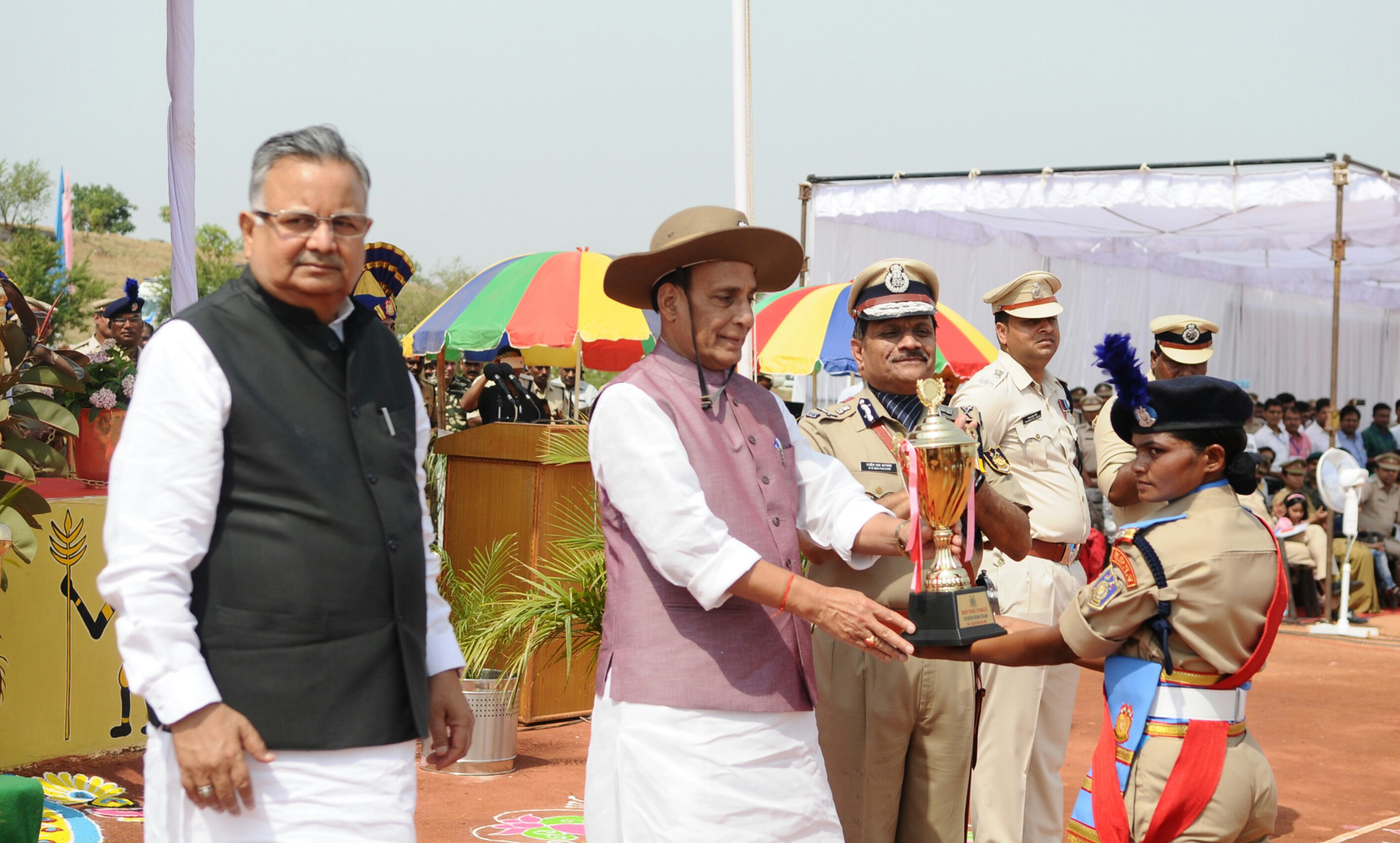 The Union Home Minister, Shri Rajnath Singh presenting trophies, during the Passing Out Parade of the Bastariya Battalion of CRPF, in Ambikapur, in Chhattisgarh on May 21, 2018. 	The Chief Minister of Chhattisgarh, Dr. Raman Singh is are also see